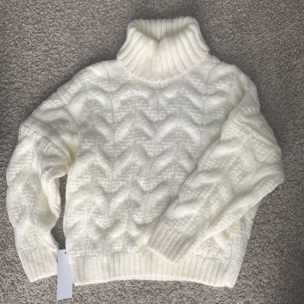 Adorable cream knit sweater with turtle neck. NWT